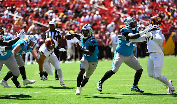 Aug 13, 2022; Landover, Maryland, USA; Carolina Panthers quarterback PJ Walker (11) scrambles against the Washington Commanders during the second half at FedExField. Mandatory Credit: Brad Mills-USA TODAY Sports
